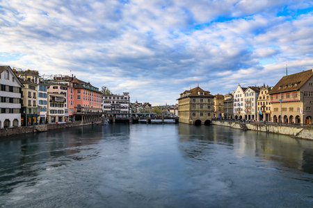 Cityscape with classic buildings on the banks of the Limmat River flowing through Altstadt or Old Town in city center of Zurich, Switzerlandの写真素材