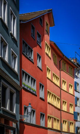 A picturesque street in historic Old Town, lined with classic buildings, traditional architecture, wooden shutters in Altstadt, Zurich, Switzerlandの写真素材