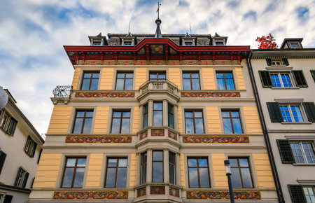A picturesque classic building with an ornate facade and roof soffit in historic Old Town, traditional architecture, in Altstadt, Zurich, Switzerlandの写真素材