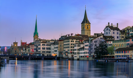 Cityscape with the Rathausbrucke bridge, Fraumunster and St Peter churches and historic buildings on the Limmat in the Altstadt, Zurich, Switzerlandの写真素材