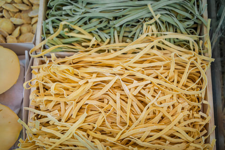 Fresh handmade spinach and traditional linguini, for sale at an artisanal pasta shop in the Old Town of Nice, South of Franceの写真素材