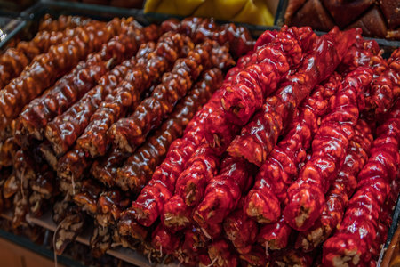 A pile of traditional churchkhela or cevizli sucuk, a string of walnuts dipped in grape juice on display at the Egyptian Bazaar, Istanbul, Turkeyの写真素材