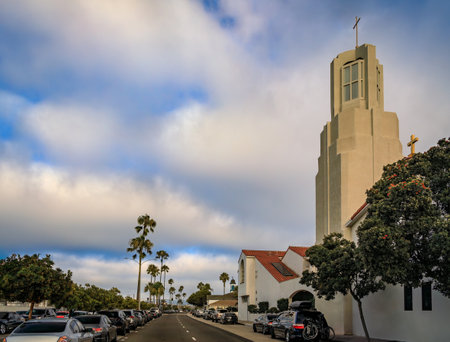 Our Lady of Mount Carmel art deco church tower rising above Balboa Boulevard in Balboa Peninsula, Newport Beach, California, palm trees along the roadの写真素材