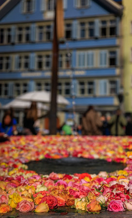 Colorful roses cover the water of a fountain in the city Old Town for the spring Easter celebration,...