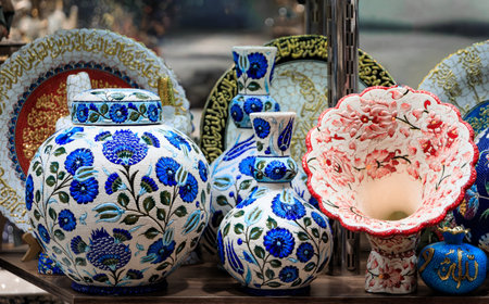 Ornate handmade Turkish ceramic Iznik pottery with a pomegranate tree of life Islamic pattern and a relief in Ottoman style in Istanbul, Turkeyの写真素材