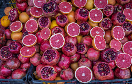 Fresh pomegranate, orange and grapefruit on display at at juice stand of a traditional street juice and smoothie seller in Istanbul, Turkeyの写真素材