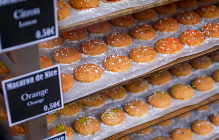 Fresh almond macaroon of Nice cookies with price tags displayed at the Cours Saleya street market in...