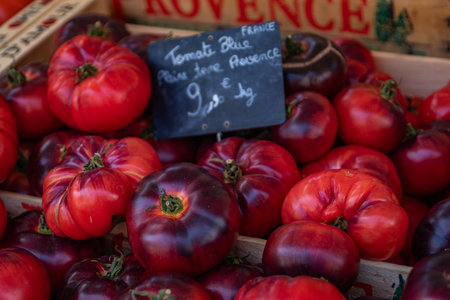 Fresh ripe blue beefsteak tomatoes at a local farmers market in Nice, South of Franceの写真素材