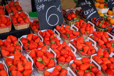 Ripe local strawberries on a fruits and vegetables stand in the Cours Saleya provencal farmers market in the Old Town of Nice, South of Franceの写真素材