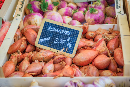 at a vegetable stand in the Cours Saleya provencal farmers market in the Old Town of Nice, South of...