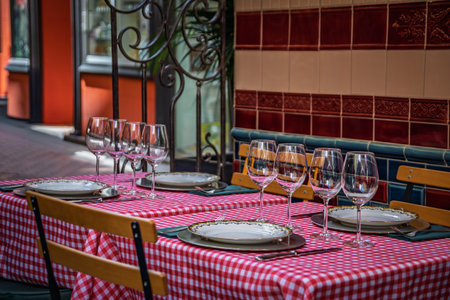 Al fresco tables with white tablecloth waiting for customers at an outdoor restaurant in the Old Town or Vieille Ville of Nice, South of Franceの写真素材