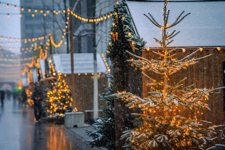 A magical scene at the Zurich Christmas Market in Switzerland, with twinkling lights and snowfall creating a winter wonderland, defocused bokehの写真素材