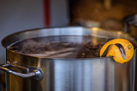Steam coming from a boiling pot with mulled wine, infused with spices and orange slices at a specialty stall, the Strasbourg Christmas Market, Franceの写真素材