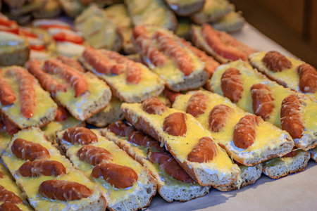 Open faced baguette sandwiches or tartine with sausages and cheese at the Christmas Market in Strasbourg, Franceの写真素材