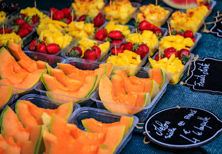 Ripe sliceed local melon on a fruits and vegetables stand in the Cours Saleya provencal farmers market in the Old Town of Nice, South of Franceの写真素材