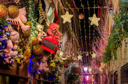 Strings of festive lights illuminate a street with half timbered houses in the Grande Ile district of Strasbourg, France, during the Christmas Marketの写真素材