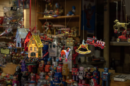 Hanging antique tin Christmas ornaments and toys at a traditional holiday toy shop, animals, trains, houses, at the Strasbourg Christmas Market Franceの写真素材
