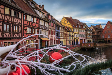 Festive decorations and ornaments on historic half timbered houses during the Christmas Market in the Little Venice Old Town of Colmar, Alsace, Franceの写真素材