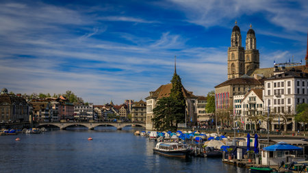 Cityscape with classic buildings on Limmat River in Altstadt Old Town and iconic Grossmunster...