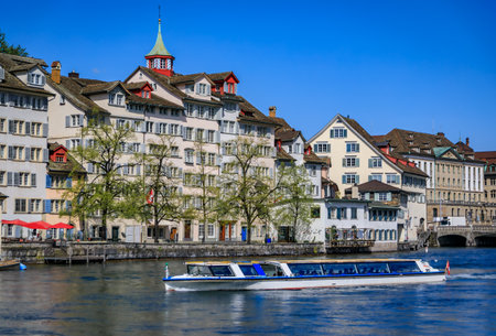 Cityscape with the iconic Fraumunster church and classic buildings on the banks of the Limmat River in the Altstadt or Old Town in Zurich, Switzerlandの写真素材
