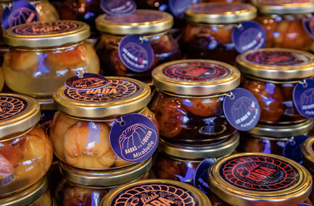 Colmar, France - December 14, 2024: Jars of Baba au Rhum or Rum Baba cakes soaked in a mirabelle plum liqueur, Christmas marketのeditorial素材