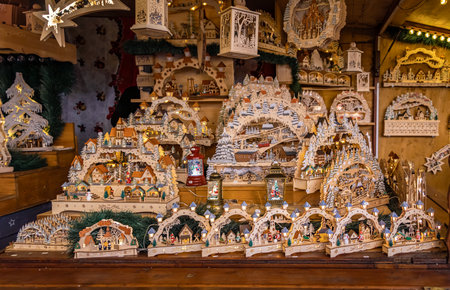 Ornate Christmas ornaments and toys at a traditional holiday toy shop, wooden carved houses, at the Strasbourg Christmas Market Franceの写真素材