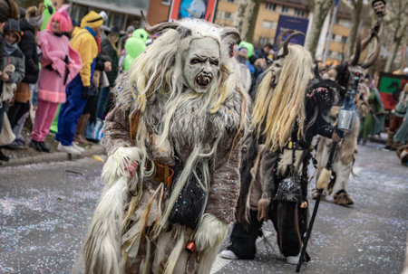 Zug, Switzerland - March 1, 2025: A person in a Tschaggatta, furry beast costume with a horned...