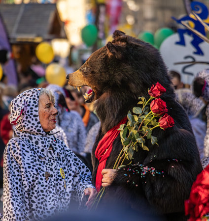 Bern, Switzerland - March 8, 2025: Dressed up performer in a bear costume celebrates the Fasnacht winter carnival parade in the historic townのeditorial素材