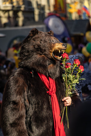 Bern, Switzerland - March 8, 2025: Dressed up performer in a bear costume celebrates the Fasnacht winter carnival parade in the historic townのeditorial素材