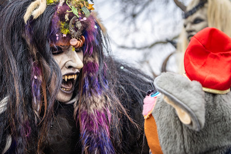 Zug, Switzerland - March 1, 2025: A person in a Tschaggatta, furry beast costume with a horned...