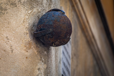 Ancient iron cannonball from 1543 siege by the Ottoman fleet, embedded in a historic stone building, a tribute to the city defiance in Nice, Franceの写真素材