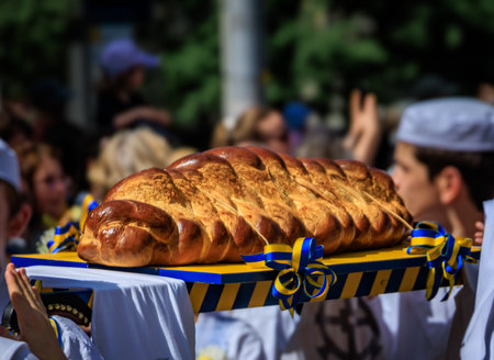 Large golden Zopf bread on a decorated platter during the Sechselauten parade, representing...