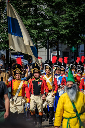 Zurich, Switzerland - April 28, 2025: Guild members in traditional historic costumes at the Sechselauten parade, celebrating the arrival of springのeditorial素材