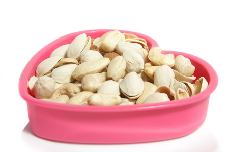 Pistachios, cashews, peanuts in a heart shapeの写真素材