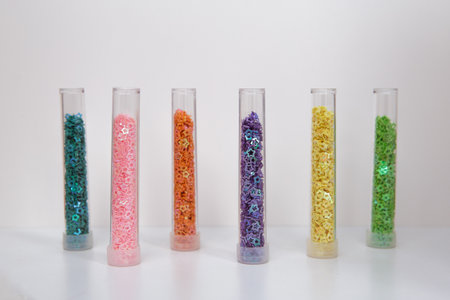 Multicolored stars glitter in glass bottlesの写真素材