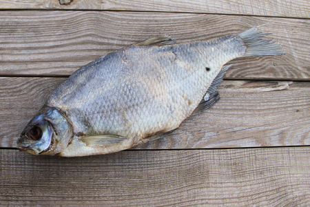Dried roach fish on wooden table. Top viewの写真素材