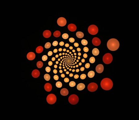 Abstract fractal spiral of golden brown balls on a black backgroundの写真素材