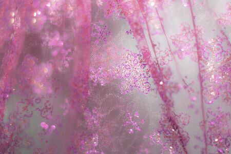 Glowing golden pink festive background with sparkles. Colored abstract blurry backgrounds. Chinese New Year and Christmas.の写真素材