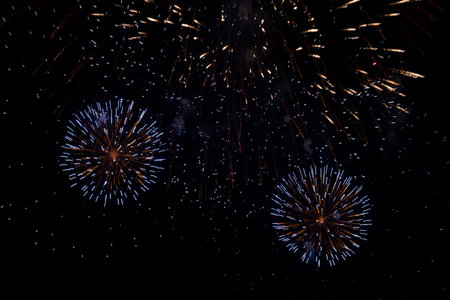 Huge explosions of purple, blue and red fireworks in the night sky. Beautiful fireworks against the dark sky. copy space, big fireworks background, holiday concept.の写真素材