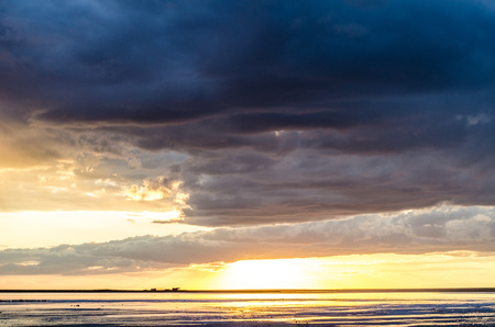 Evening sunset on the Salt lake, clouds and calm water, beautiful landscape, reflection in the waterの写真素材