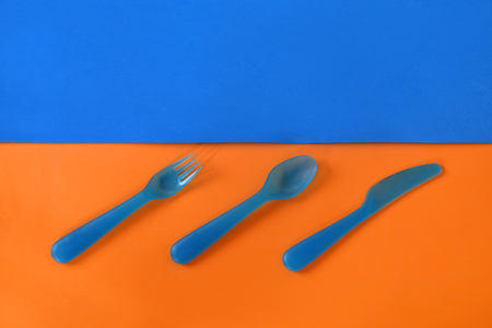 Cutlery on a blue-orange background. Dishesの写真素材