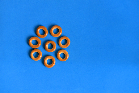 Little rolls on a blue background. Kalachi, laid out in the form of a flower. Confectionery kalachi....
