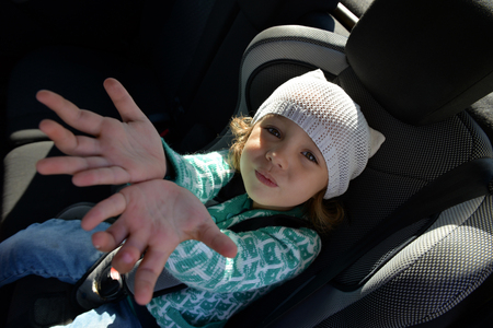Little girl in the car. Portrait of a girl in the carの写真素材
