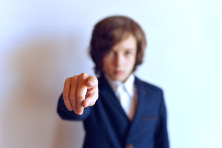 The schoolboy's hand is extended. A young man with an outstretched hand. The schoolboy is showing forth.の写真素材