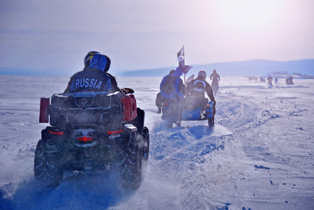 Extreme sport. Winter race on motorcycles and ATVs. Motorcycles and quads on the winter road.の写真素材
