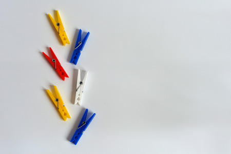 Multi-colored clothespins on a white background. Funny colored clothespins. Designer backgroundの写真素材
