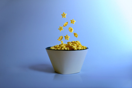 Dry breakfast in a plate on a blue background. Healthy food. Dietary products.