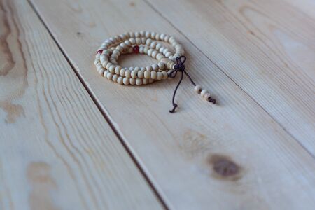 Rosary of wood are on the light  wooden table Ring shapedの写真素材