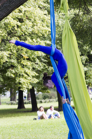 Young gymnast doing exercise on aerial silksの写真素材