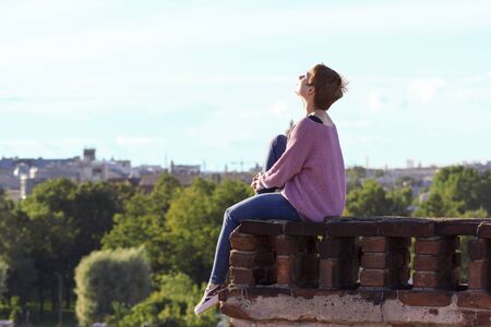 Brave girl walking on the roof of Saint-Petersburgの写真素材
